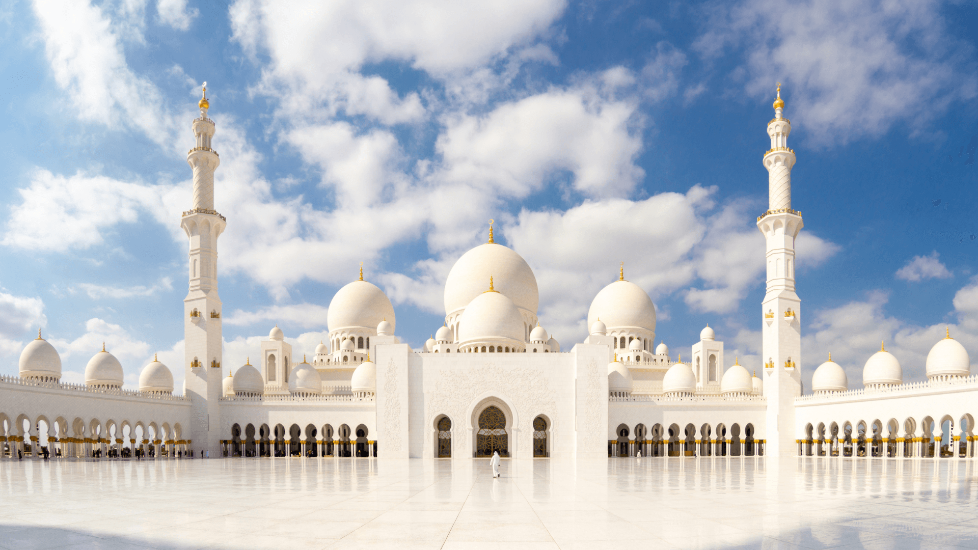 "Marvel at the stunning white domes and intricate artistry of the Sheikh Zayed Grand Mosque, a symbol of peace and grandeur in Abu Dhabi."