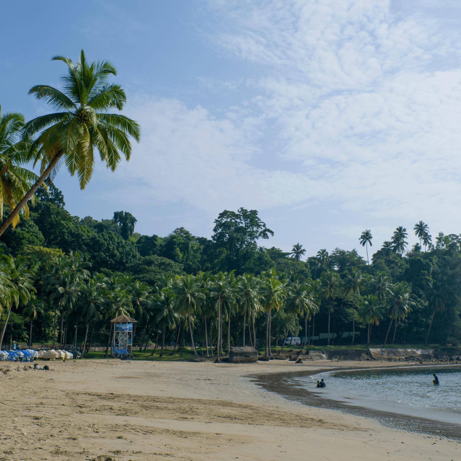 Experience the tranquil beauty of this palm-fringed beach, perfect for swimming and relaxation.