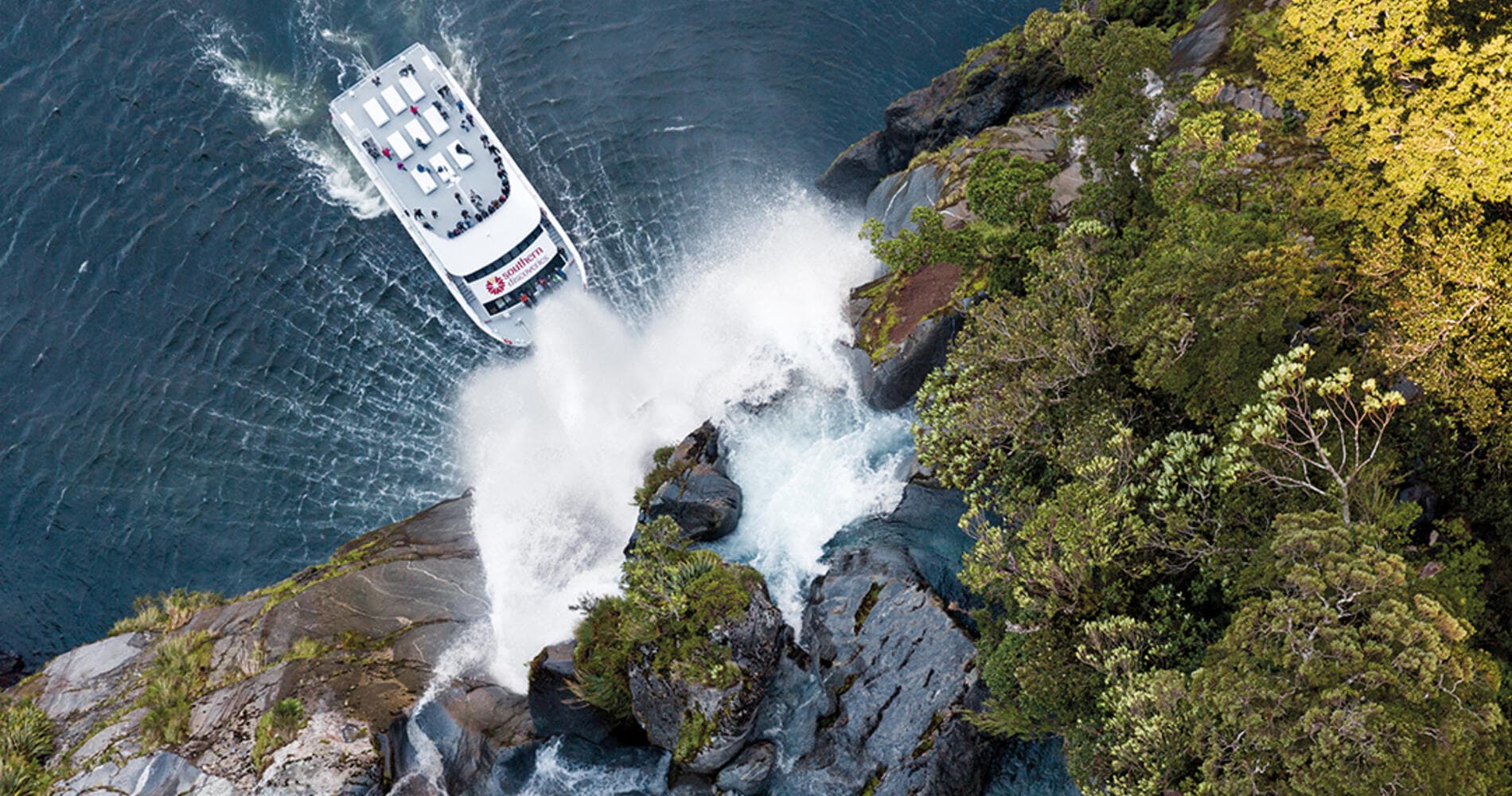 Milford Sound Cruise – Sail through breathtaking fjords with waterfalls and towering cliffs.