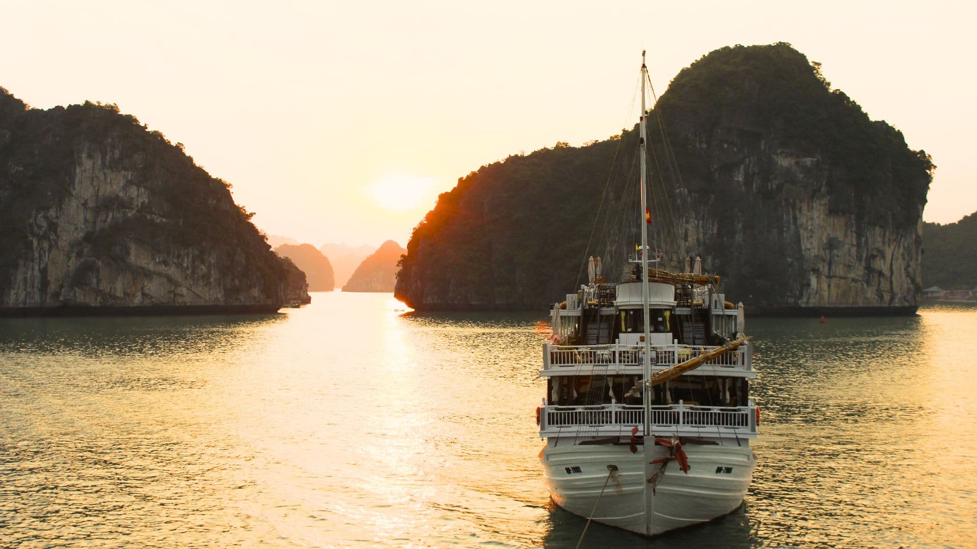 ChatGPT said: A Halong Bay sunset cruise offers a breathtaking scene of golden light reflecting off emerald waters and towering limestone cliffs, creating a magical, tranquil atmosphere.